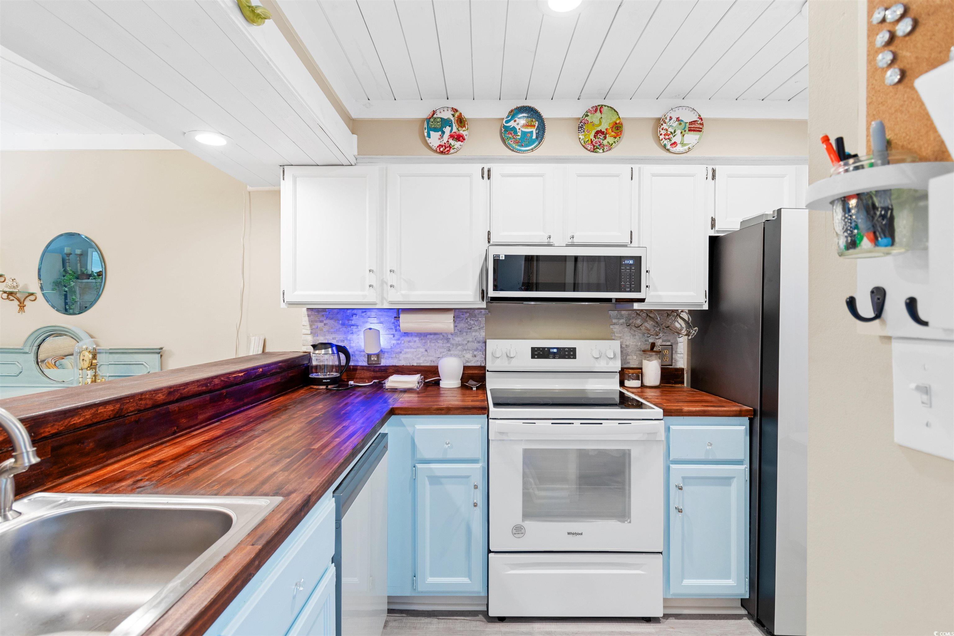 1830 Fairway Ridge Drive, Unit 6F Myrtle Beach, SC 29575 - Photo 10 of 31 Kitchen featuring white cabinets, wooden counters,