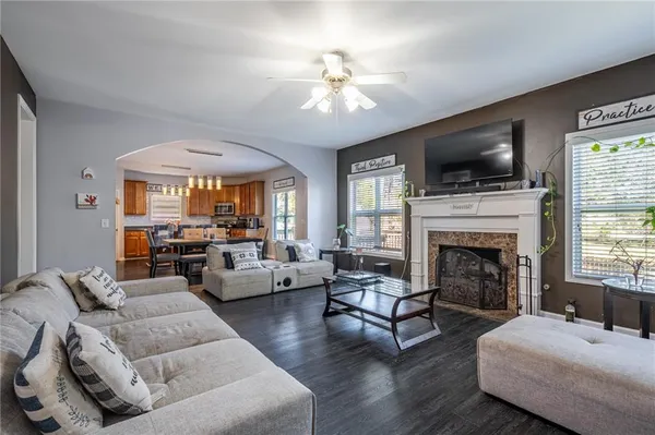 a living room with furniture fireplace and flat screen tv