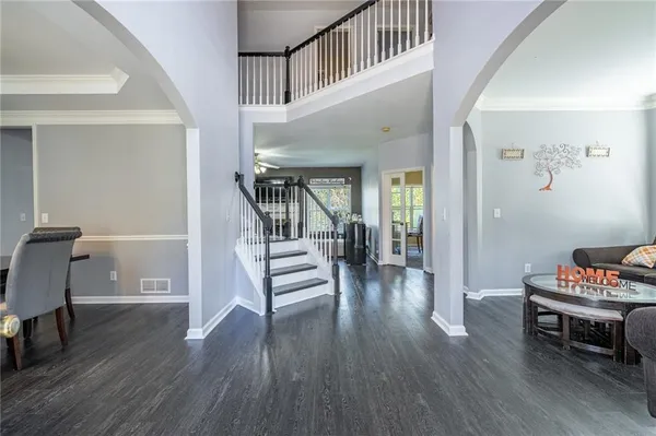 a living room with furniture and a wooden floor