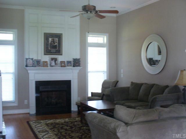2125 Conroy Way Willow Spring, NC 27592 - Photo 3 of 12 Family room is open to dining room and kitchen for easy entertaining. Gorgeous hardwoods and custom mantle on gas log fireplace.