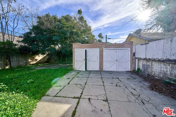 a view of a backyard with a large tree