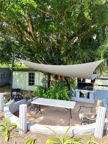 a swimming pool with outdoor seating and yard