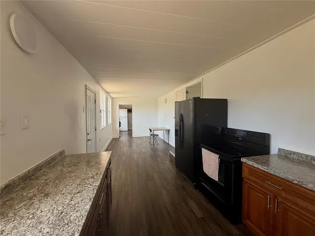 a view of a kitchen with wooden floor