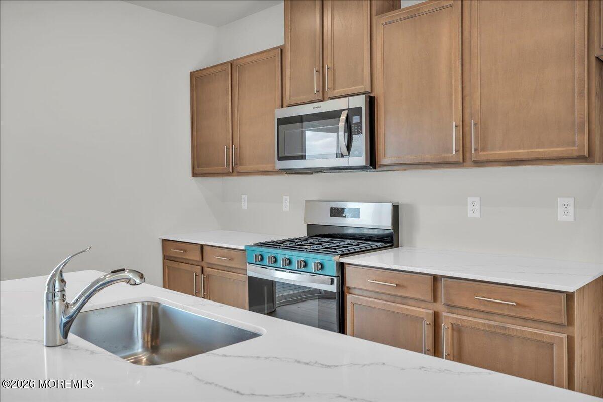 220 Sandy Rdg Road Sicklerville, NJ 08081 - Photo 8 of 24 a kitchen with cabinets stainless steel appliances and a sink