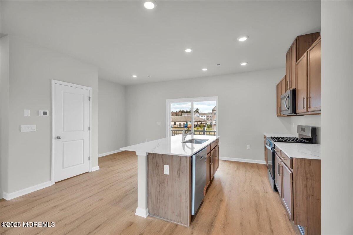220 Sandy Rdg Road Sicklerville, NJ 08081 - Photo 10 of 24 a kitchen with stainless steel appliances granite countertop a sink stove and wooden floor