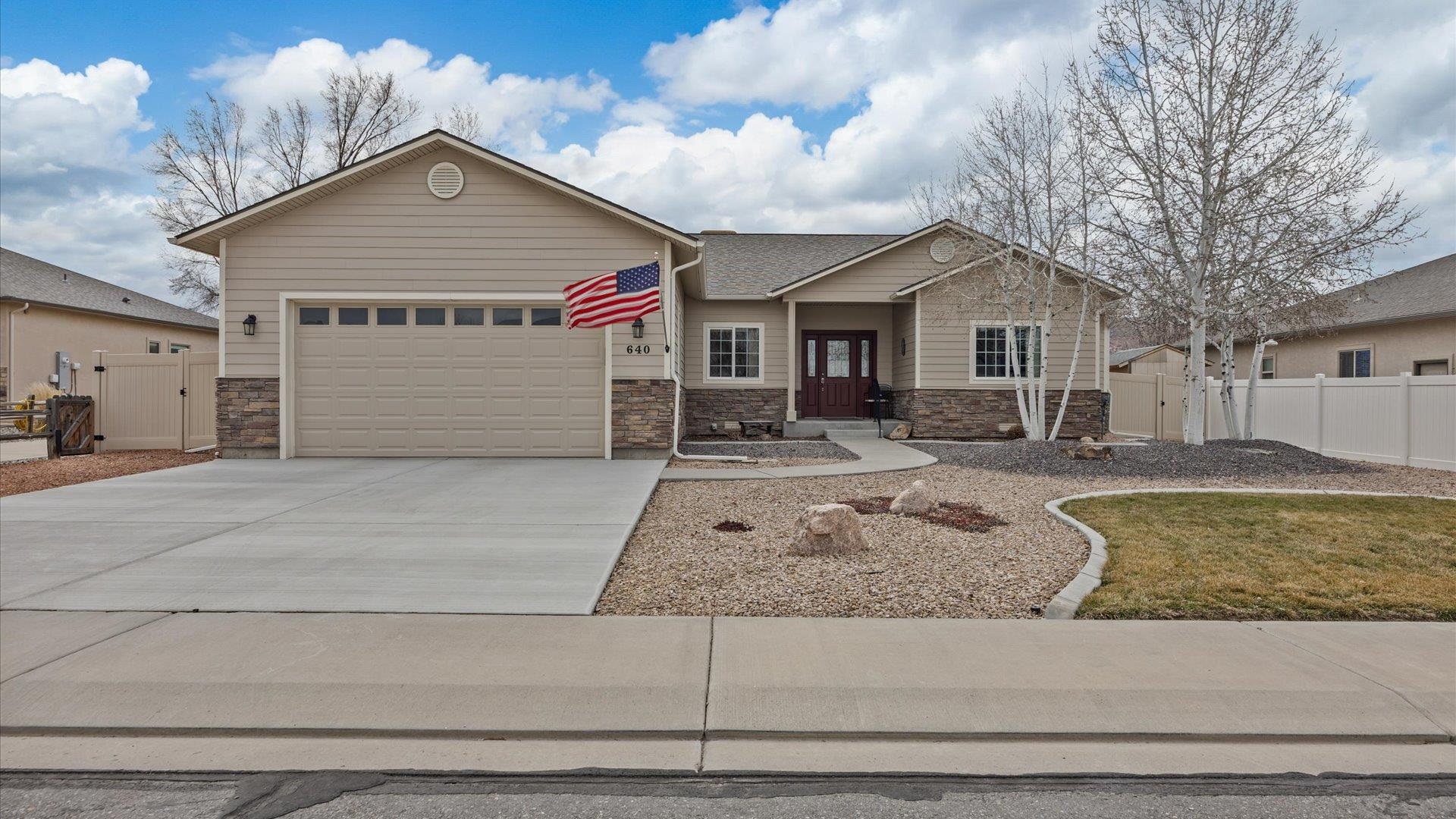 640 Beech Avenue Fruita, CO 81521 - Photo 1 of 34 a front view of a house with a yard and garage