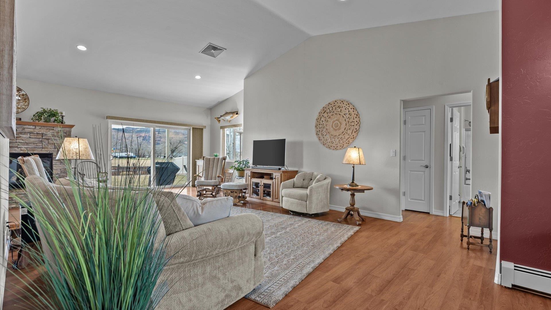 640 Beech Avenue Fruita, CO 81521 - Photo 12 of 34 a living room with furniture a table and a chandelier
