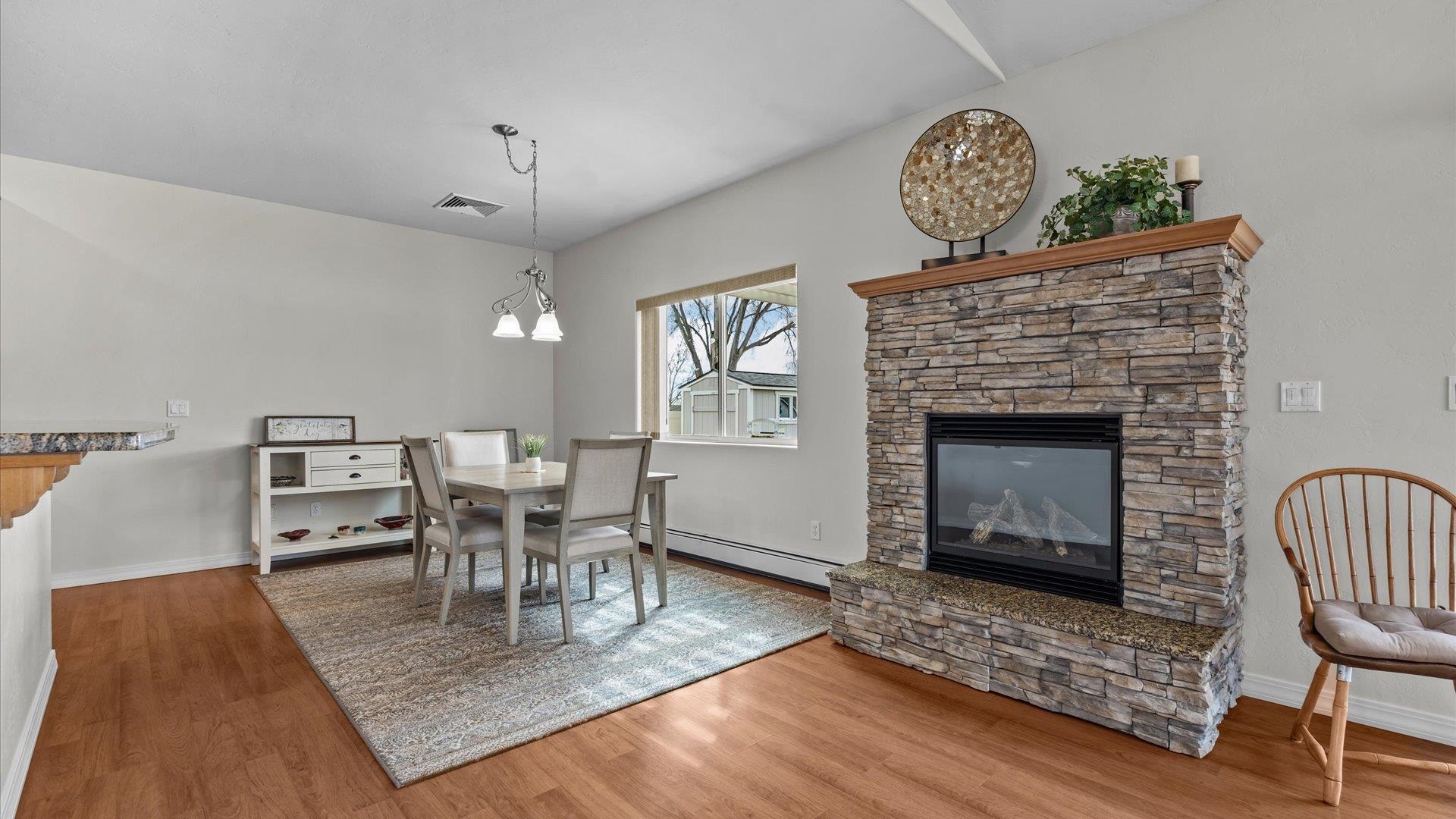 640 Beech Avenue Fruita, CO 81521 - Photo 13 of 34 a living room with furniture a fireplace and a table