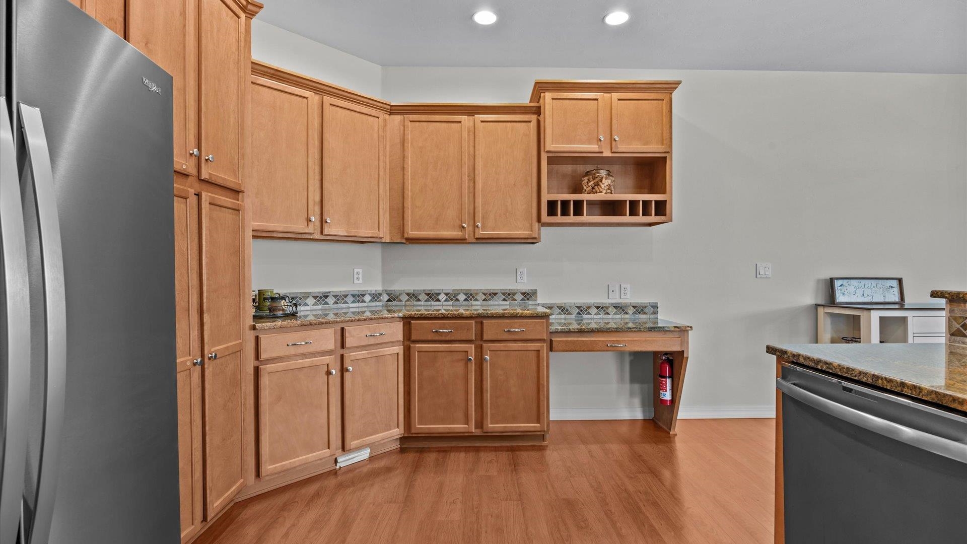 640 Beech Avenue Fruita, CO 81521 - Photo 17 of 34 a kitchen with stainless steel appliances granite countertop a stove a sink and a refrigerator