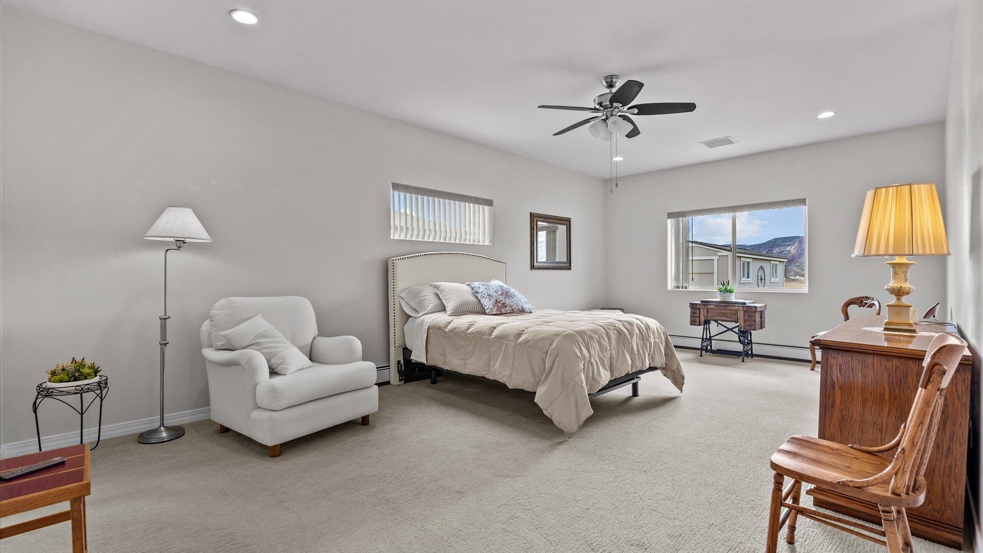 640 Beech Avenue Fruita, CO 81521 - Photo 19 of 34 a spacious bedroom with a bed and couch