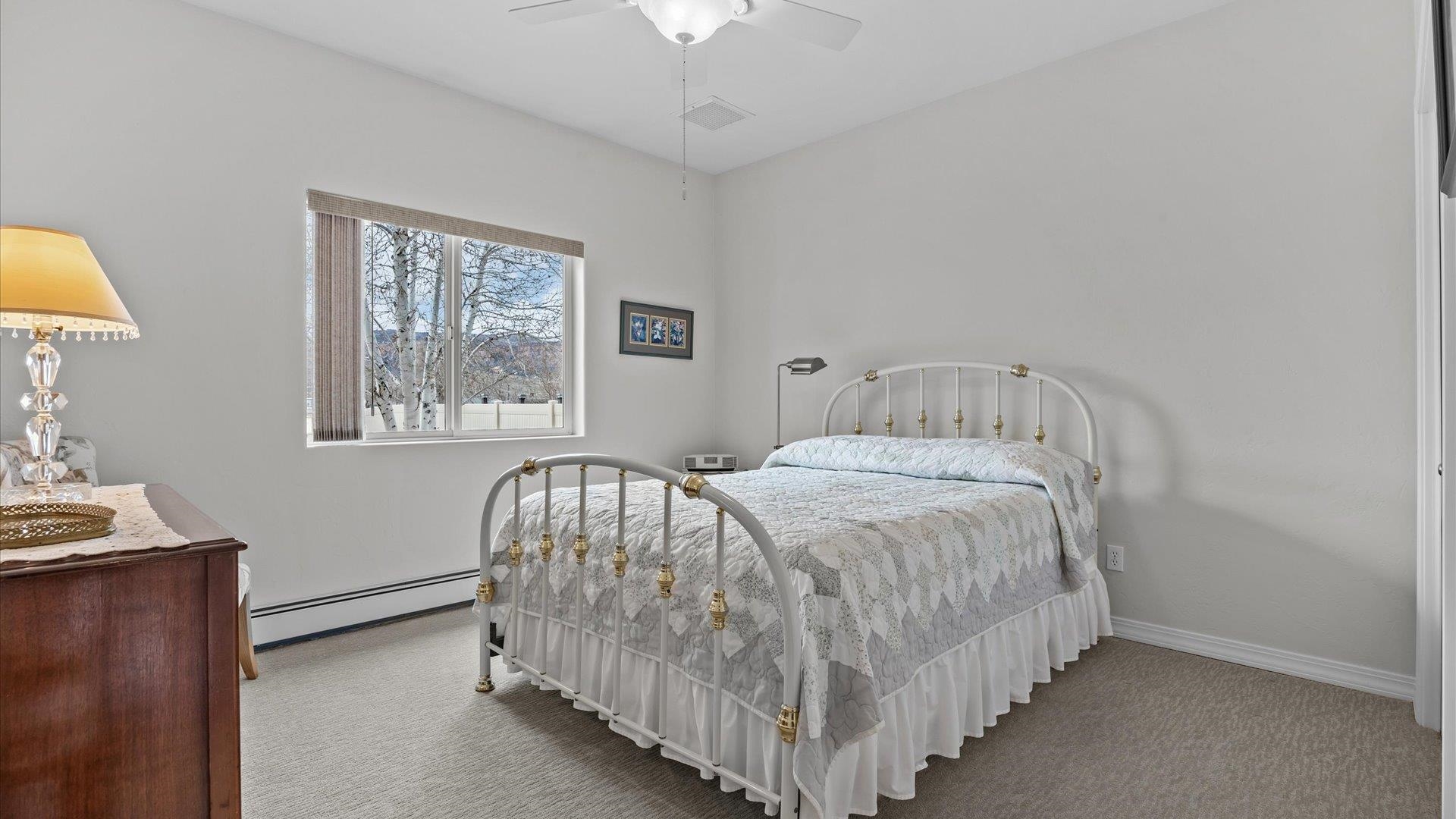 640 Beech Avenue Fruita, CO 81521 - Photo 23 of 34 a bedroom with a bed and a window
