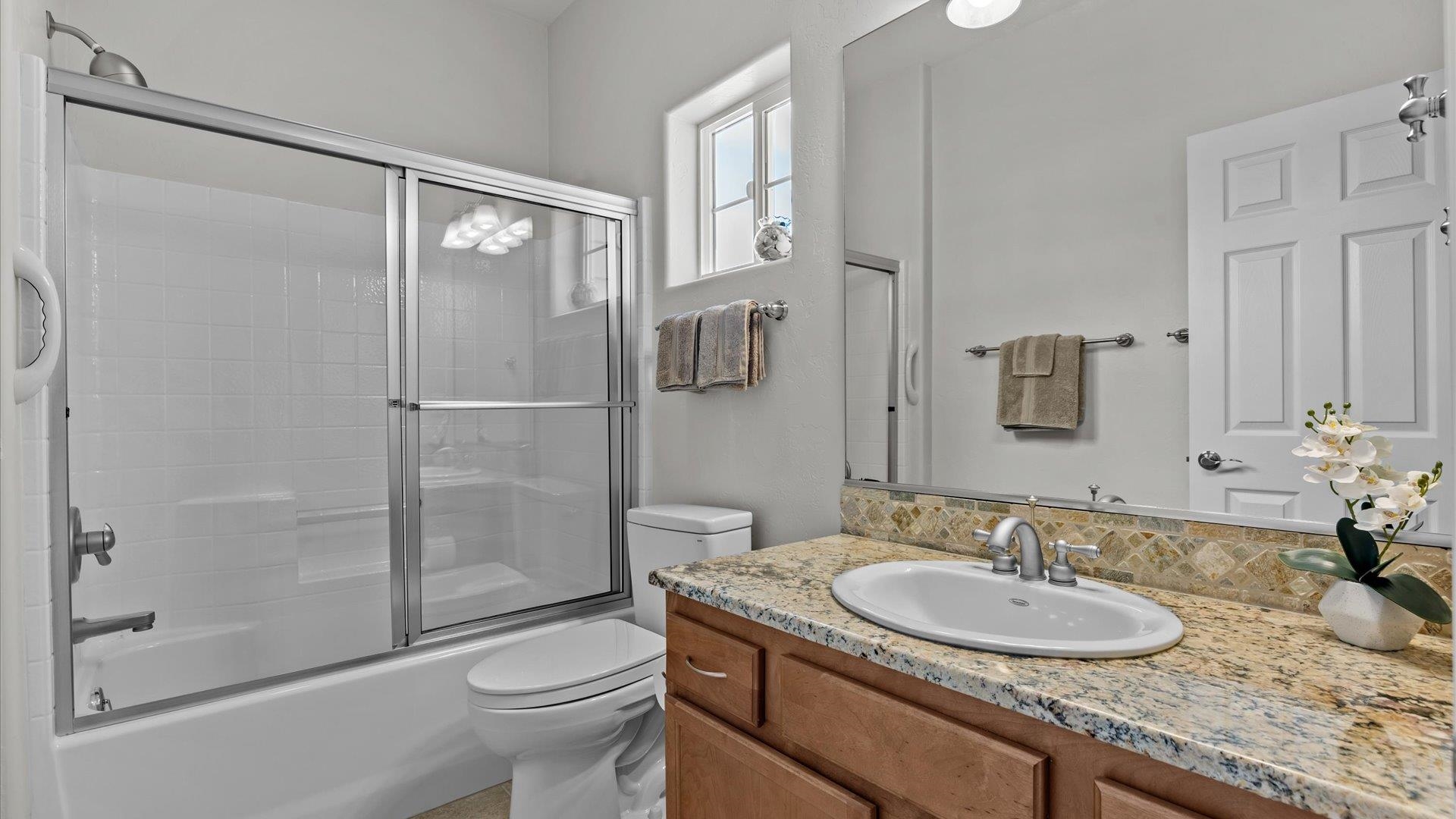 640 Beech Avenue Fruita, CO 81521 - Photo 26 of 34 a bathroom with a granite countertop sink toilet and shower