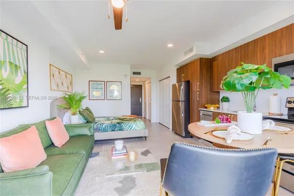 a living room with furniture and a potted plant