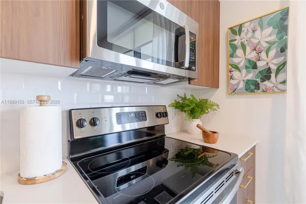a stove top oven sitting inside of a kitchen
