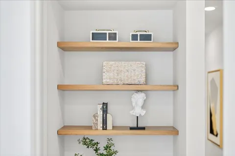 a bedroom with a bed and a potted plant