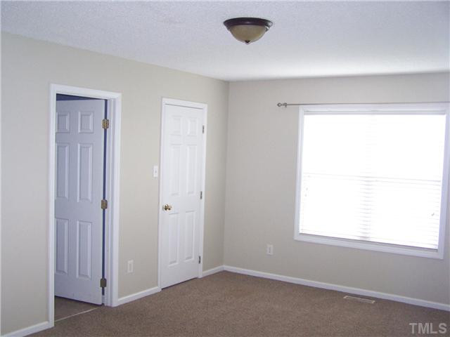 1257 Sanders Road Benson, NC 27504 - Photo 8 of 15 a view of an empty room with a window