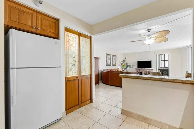 a view of kitchen with furniture and refrigerator