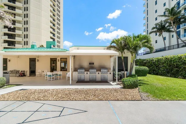 a view of a patio with couches and potted plants