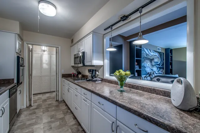 a kitchen with sink and refrigerator