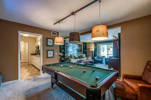 a room with pool table table tennis pool table and a chandelier