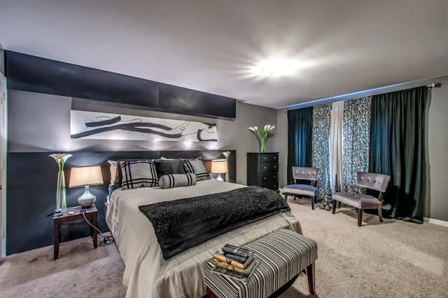 a bedroom with a bed and cabinets