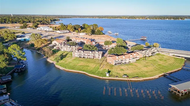 an aerial view of a swimming pool with an outdoor space and seating area