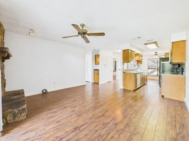 a view of a kitchen with wooden floor and a sink