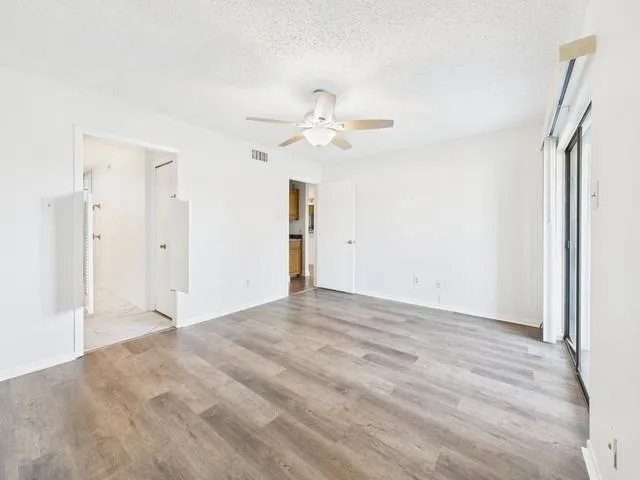 a view of an empty room with a ceiling fan