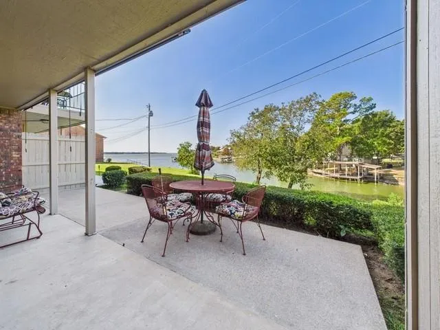 a view of a patio with table and chairs and potted plants
