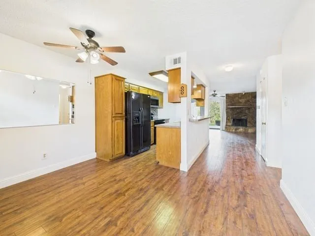 a view of a kitchen with wooden floor and a kitchen space