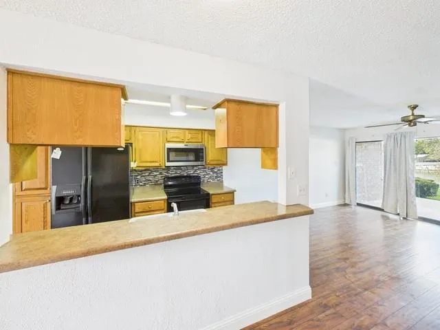 a kitchen with stainless steel appliances a refrigerator and a stove