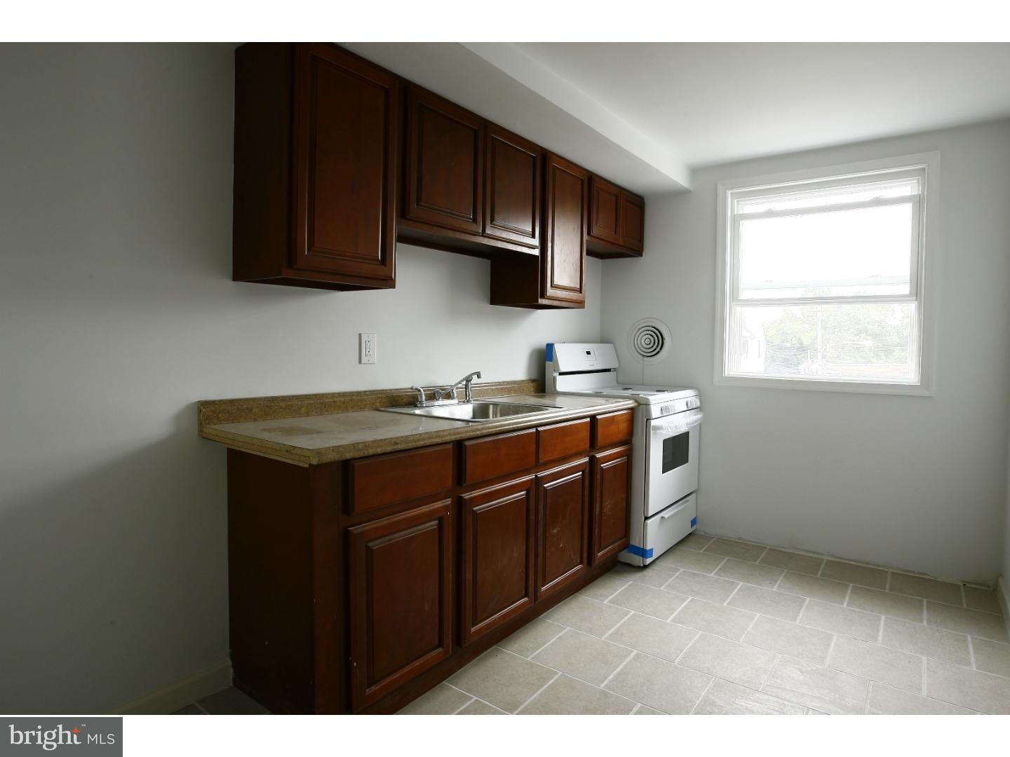 7136 Clinton Road Upper Darby, PA 19082 - Photo 2 of 10 a kitchen with stainless steel appliances granite countertop a sink stove and microwave