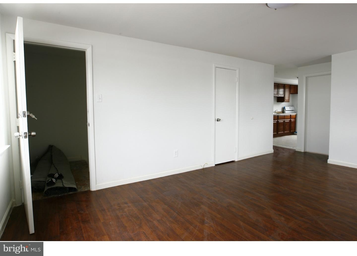 7136 Clinton Road Upper Darby, PA 19082 - Photo 4 of 10 a view of an empty room and closet with wooden floor