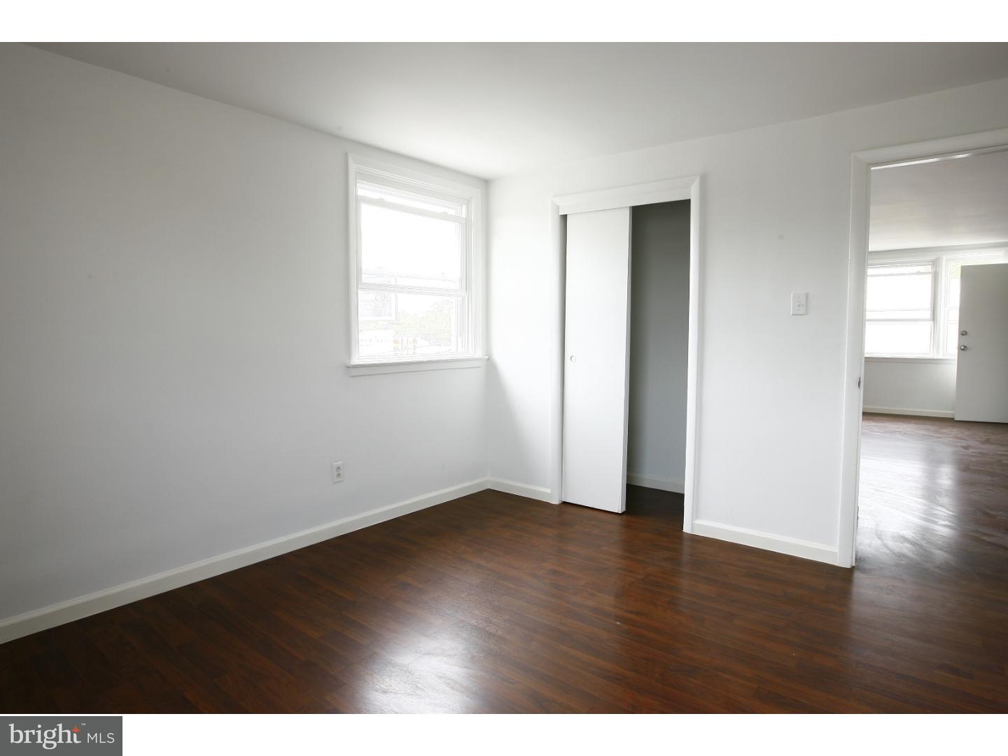 7136 Clinton Road Upper Darby, PA 19082 - Photo 6 of 10 a view of an empty room with wooden floor and a window