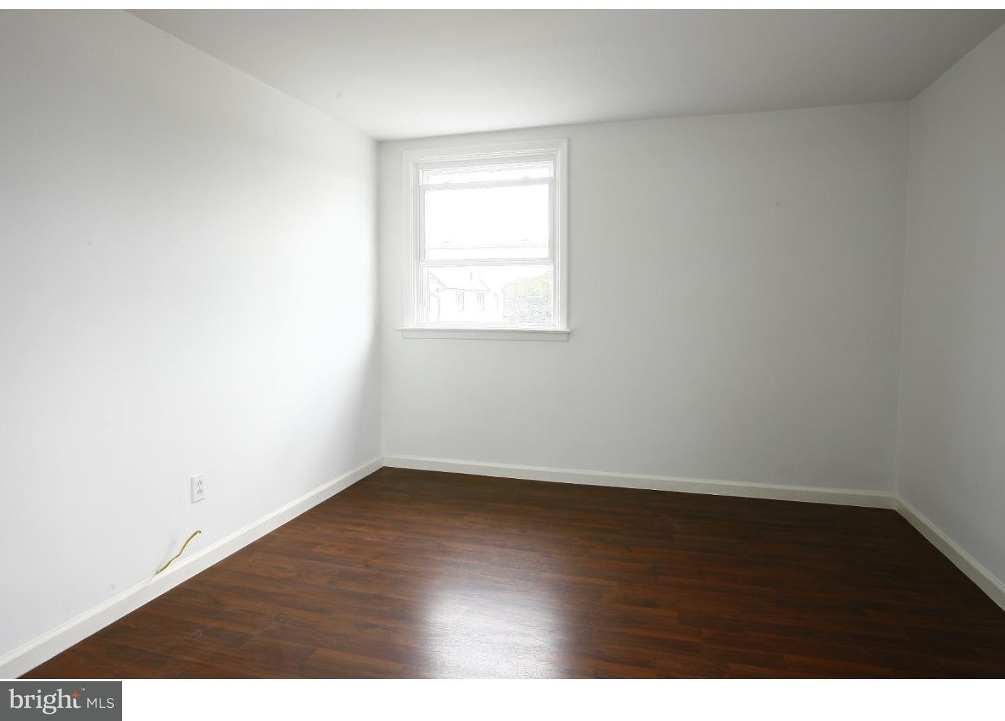 7136 Clinton Road Upper Darby, PA 19082 - Photo 7 of 10 an empty room with wooden floor and windows