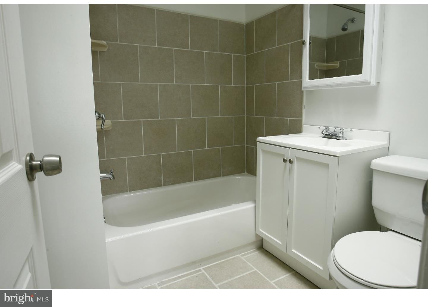 7136 Clinton Road Upper Darby, PA 19082 - Photo 9 of 10 a bathroom with a toilet a sink and bathtub