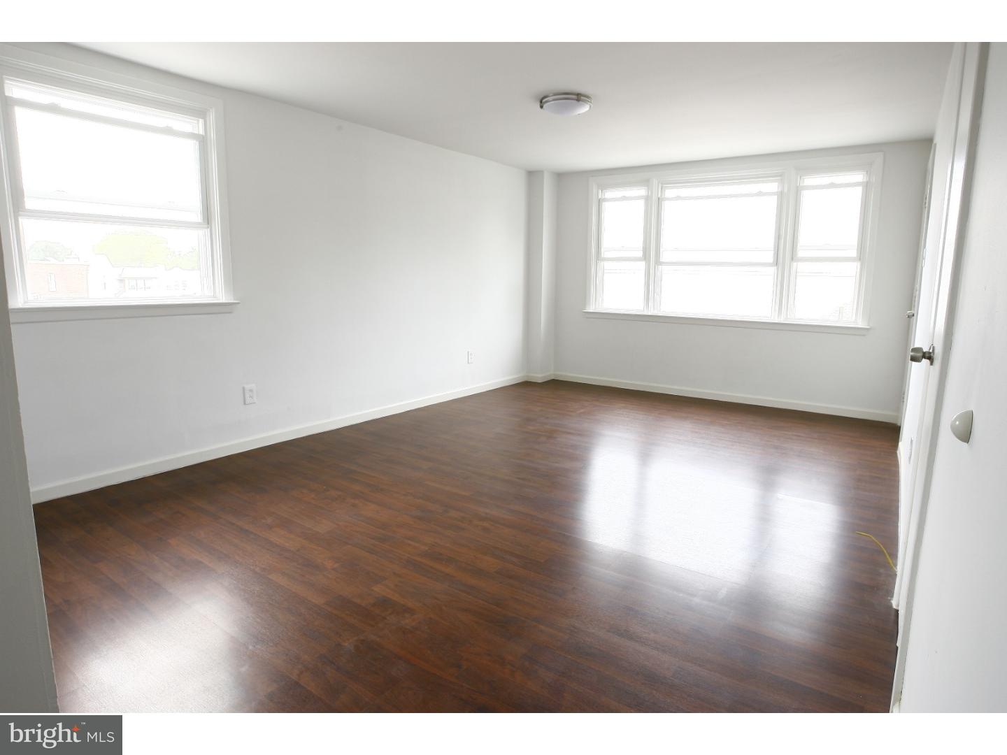 7136 Clinton Road Upper Darby, PA 19082 - Photo 10 of 10 a view of an empty room with wooden floor and a window