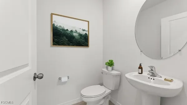 a bathroom with a sink mirror and toilet