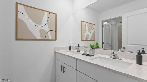 a bathroom with a double vanity sink and a mirror