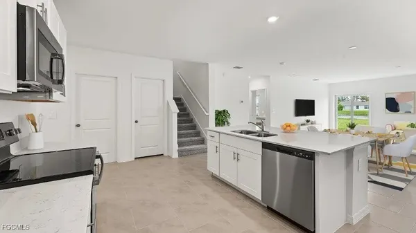 a kitchen with stainless steel appliances a sink stove and refrigerator