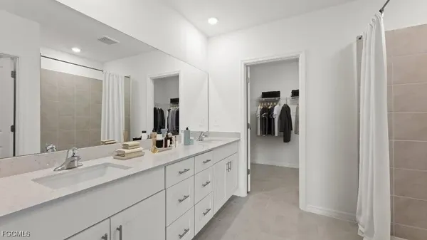 a bathroom with a double vanity sink and a mirror