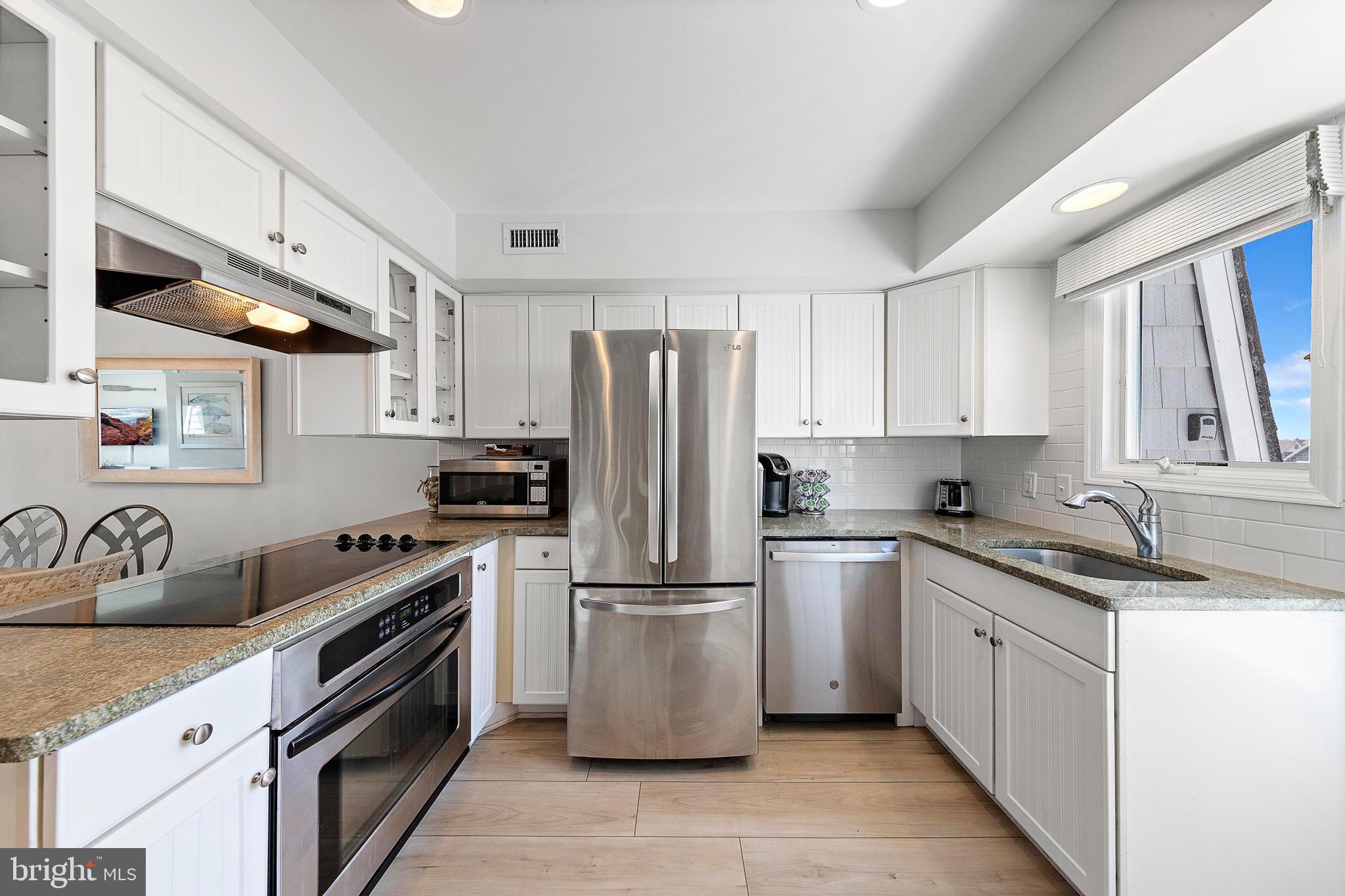 1 Centre Street, Unit 1 Beach Haven, NJ 08008 - Photo 12 of 40 a kitchen with a stove sink and refrigerator