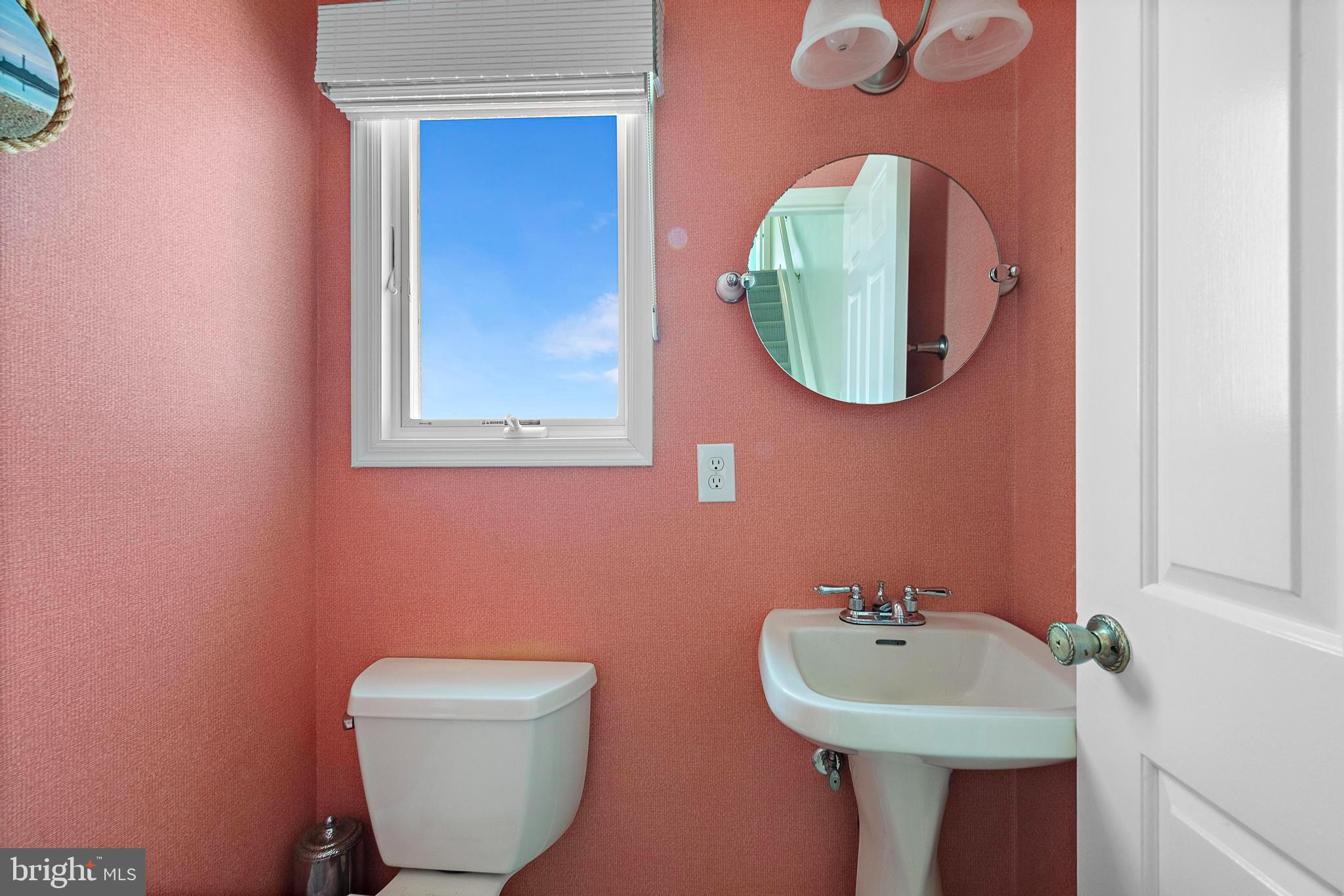 1 Centre Street, Unit 1 Beach Haven, NJ 08008 - Photo 22 of 40 a bathroom with a toilet sink and mirror