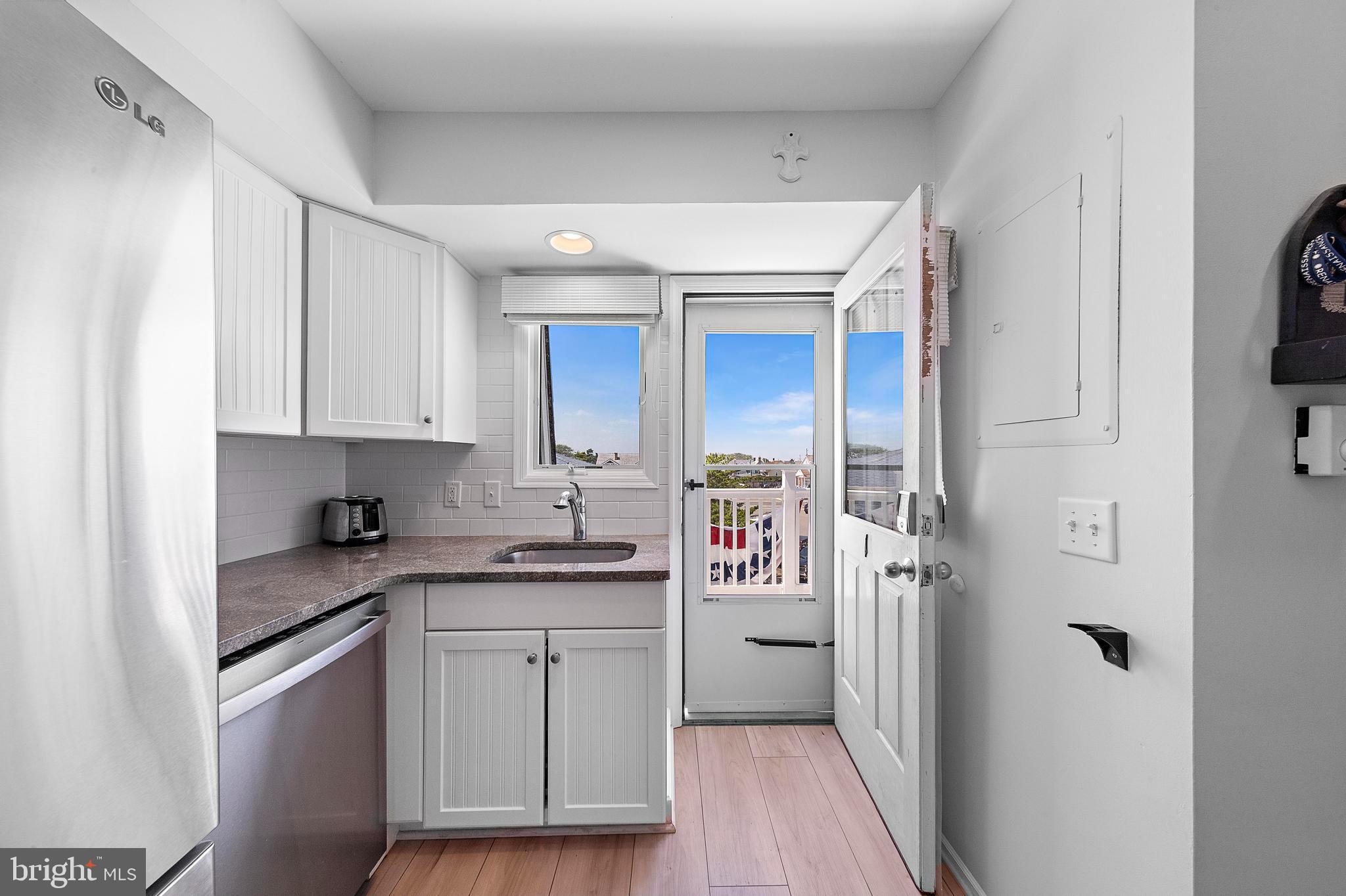 1 Centre Street, Unit 1 Beach Haven, NJ 08008 - Photo 30 of 40 a kitchen with stainless steel appliances a sink and cabinets