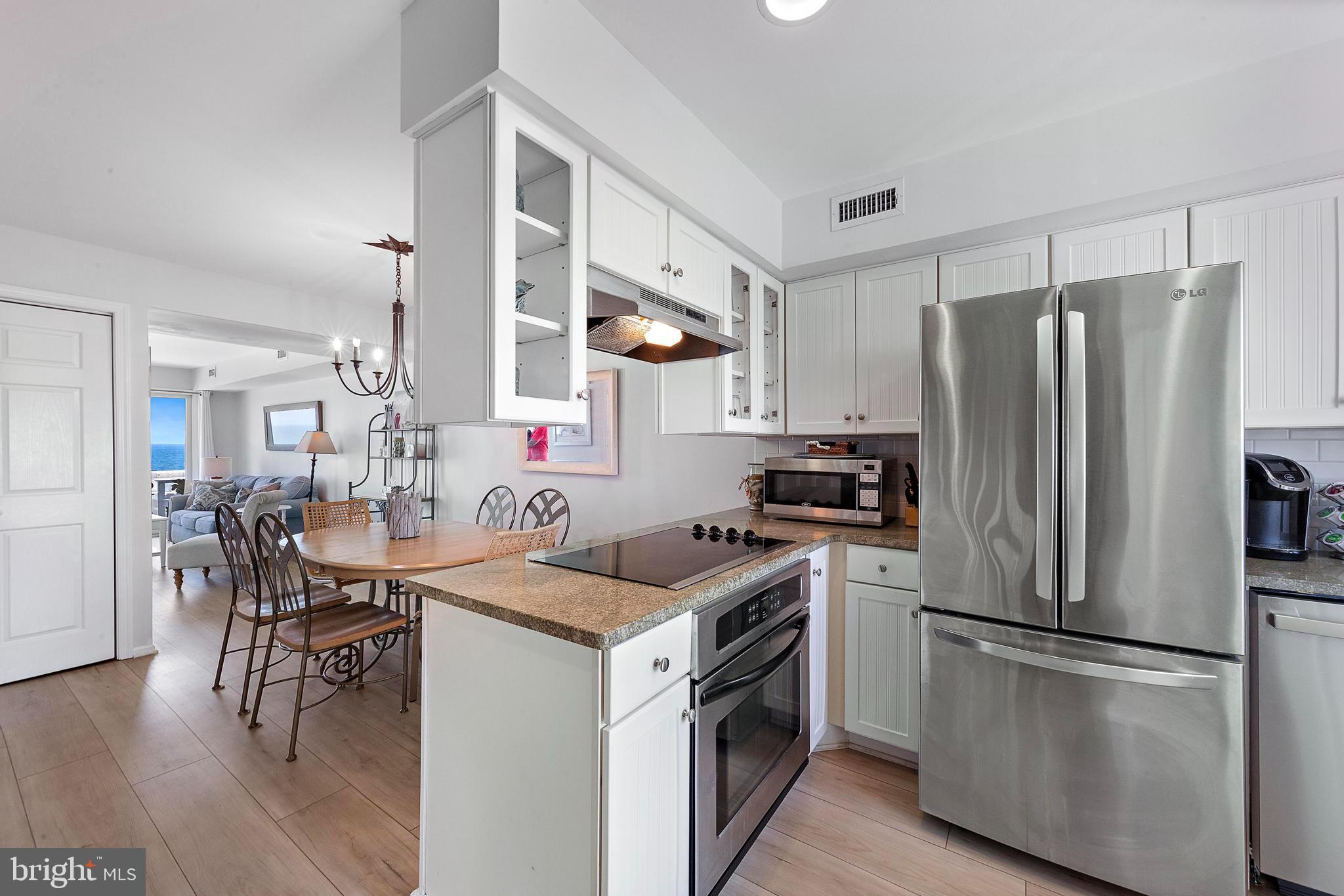 1 Centre Street, Unit 1 Beach Haven, NJ 08008 - Photo 8 of 40 a kitchen with a stove a refrigerator and a dining table