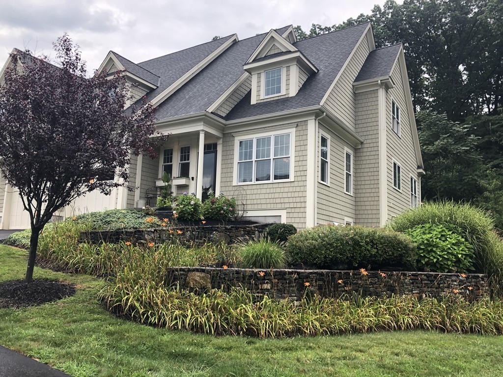 a front view of a house with a garden