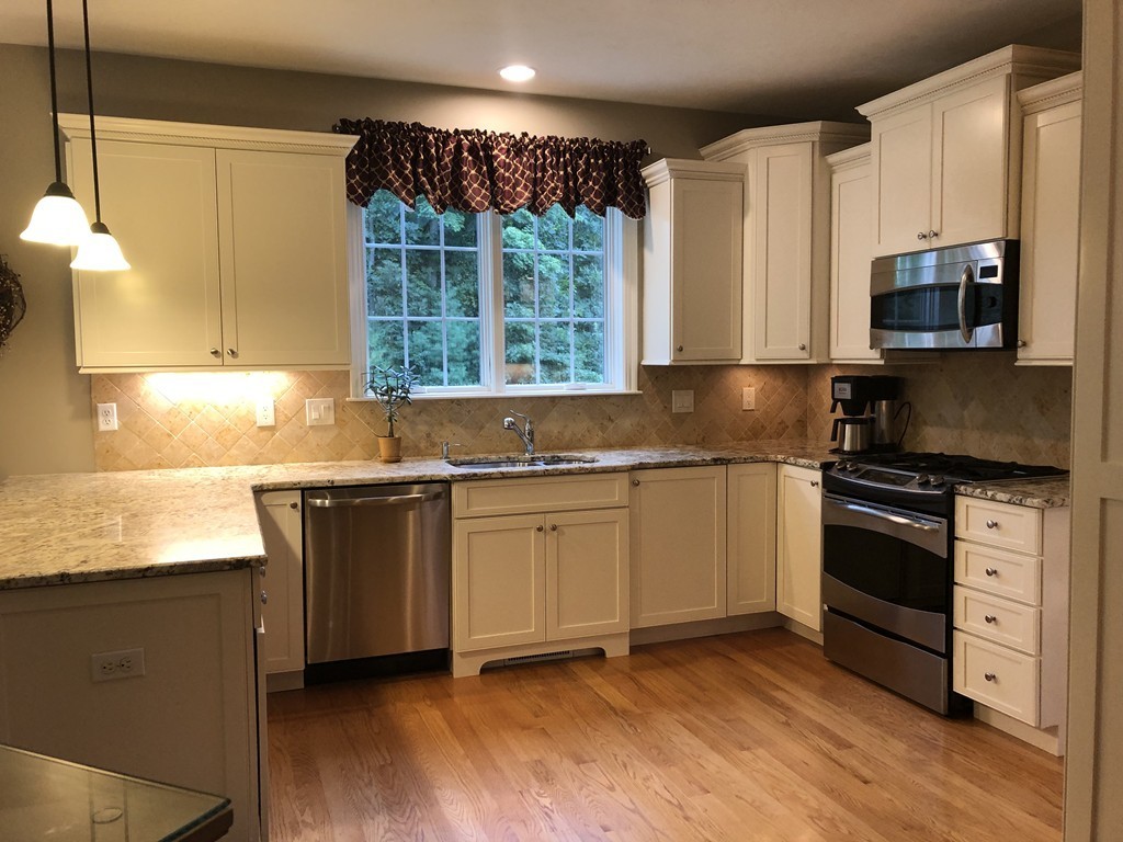 6 Adams Farm Road, Unit 6 Shrewsbury, MA 01545 - Photo 11 of 38 a kitchen with granite countertop a sink cabinets and stainless steel appliances