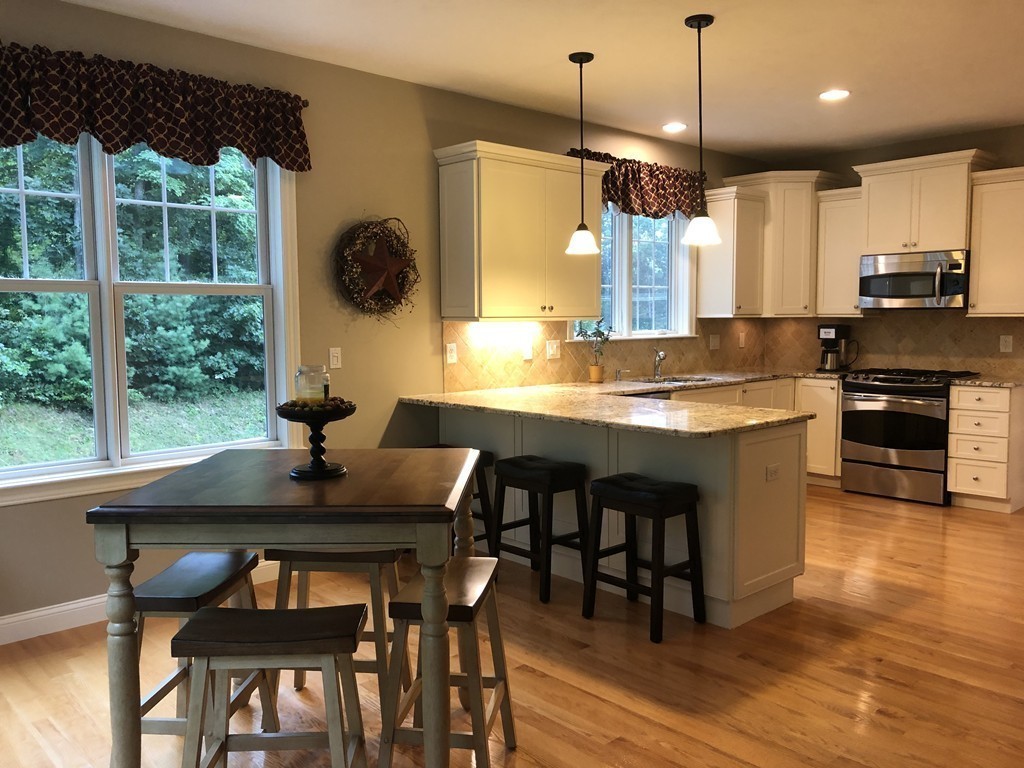 6 Adams Farm Road, Unit 6 Shrewsbury, MA 01545 - Photo 12 of 38 a view of a dining room and kitchen with a table chairs