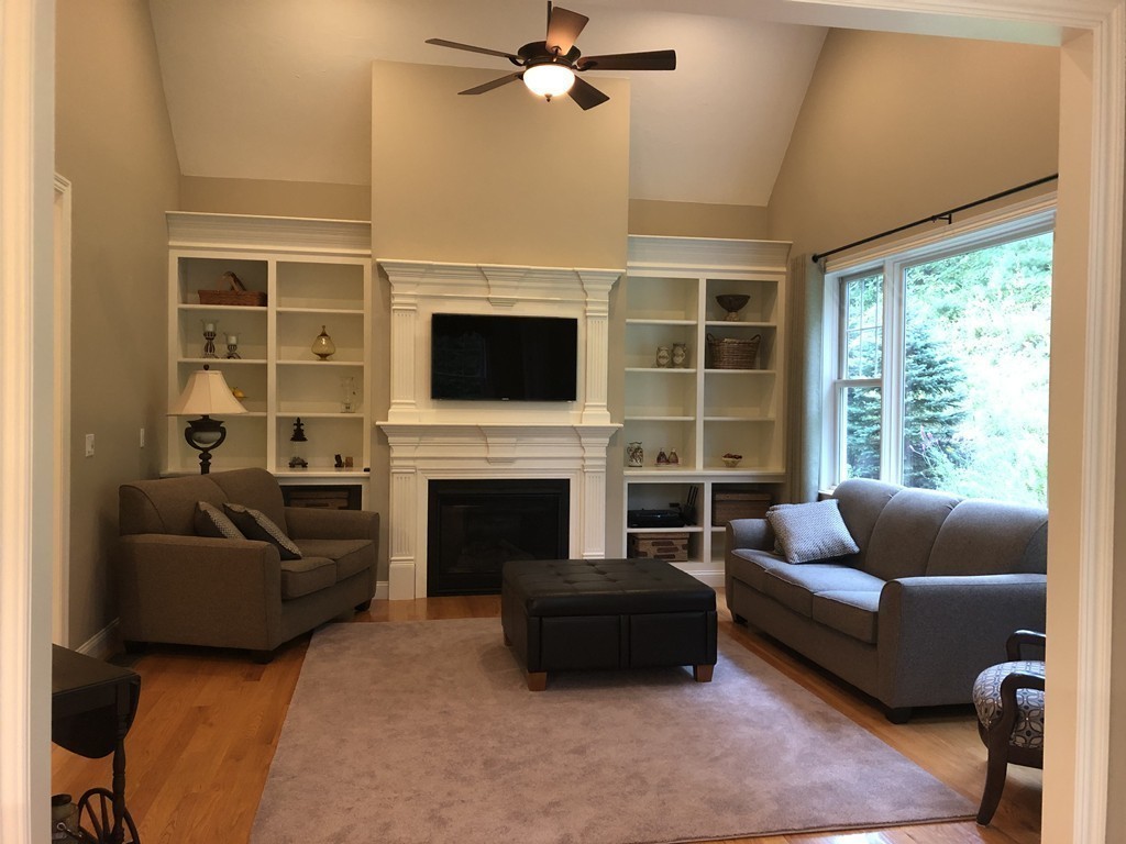 6 Adams Farm Road, Unit 6 Shrewsbury, MA 01545 - Photo 17 of 38 a living room with furniture a flat screen tv and a fireplace