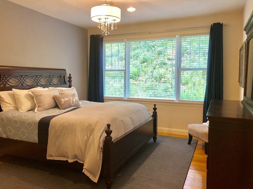 6 Adams Farm Road, Unit 6 Shrewsbury, MA 01545 - Photo 22 of 38 a bed sitting in a bedroom next to a window